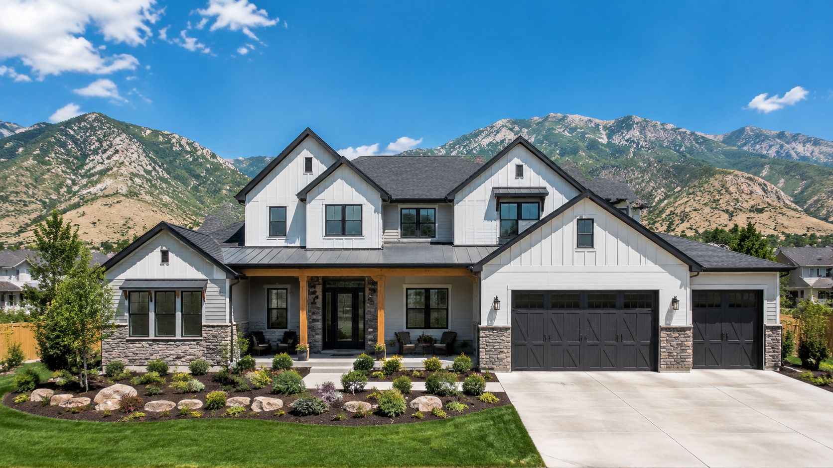 A luxurious two-story home with white board and batten siding, stone accents, and a large garage.