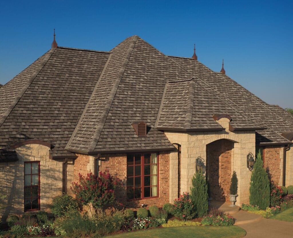 A photo displaying GAF's Camelot Aged Oak shingles on a house